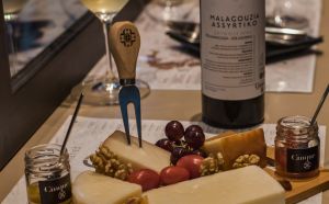 Home Greek wine and cheese pairing in Athens with wine bottle cheeses grapes and Cinque deli products